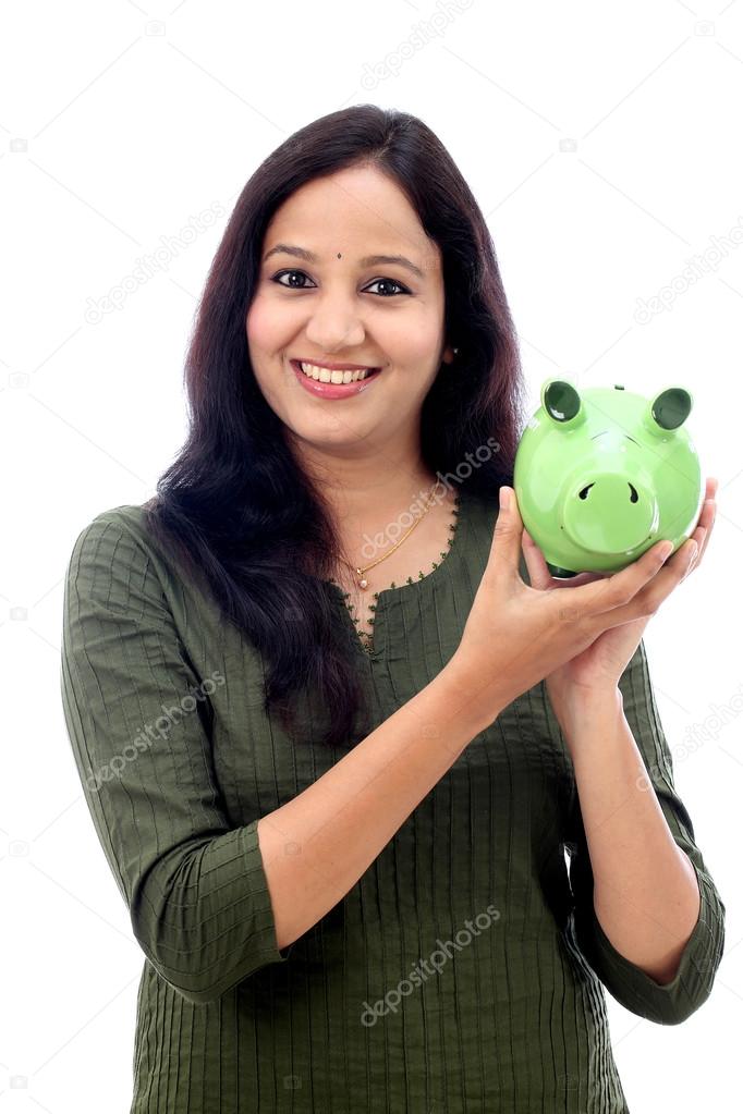 Young Woman Saves Money in Piggy bank