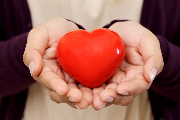 Red heart shape in the hands — Stock Photo, Image