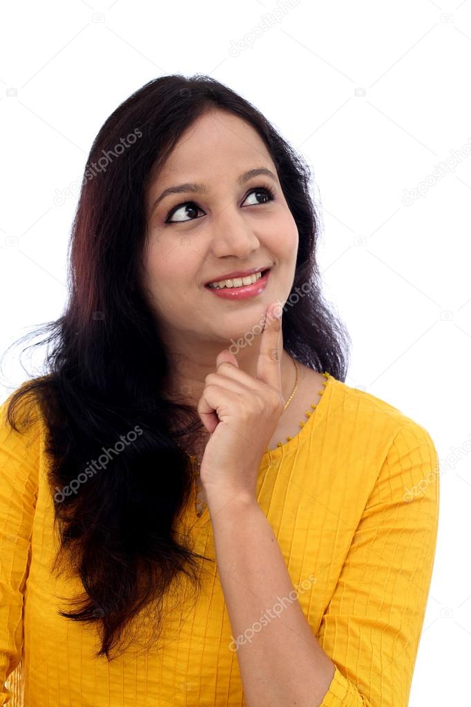 Happy young woman thinking against white background