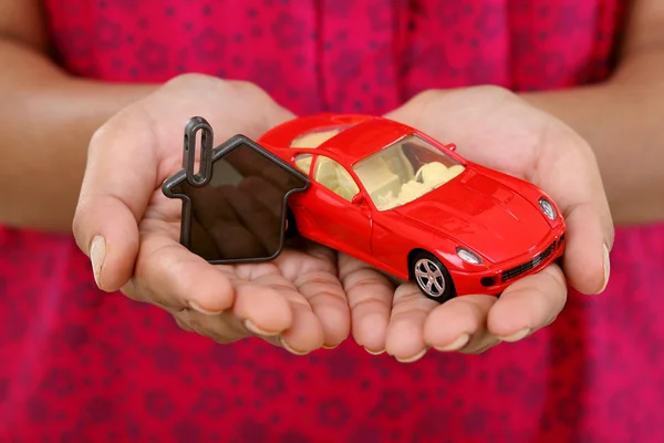 Hands with keys and red toycar — Stock Photo, Image