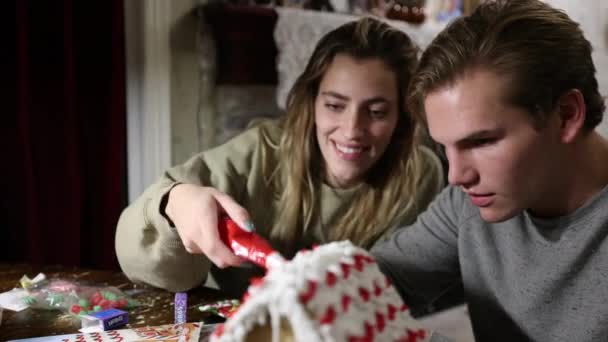 Young Couple Building Gingerbread House Smile Table — Stock Video