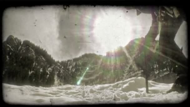 Mountain climber hikes toward sun. Vintage stylized video clip. — Stock Video
