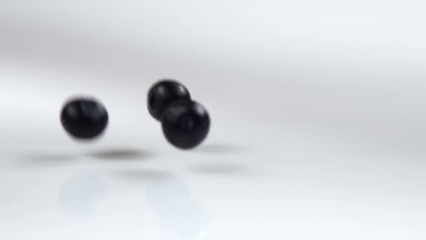 Blueberries dropping onto a table — Stock Video