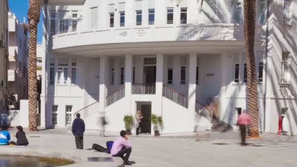 Plaza ocupada frente a un edificio blanco — Vídeos de Stock