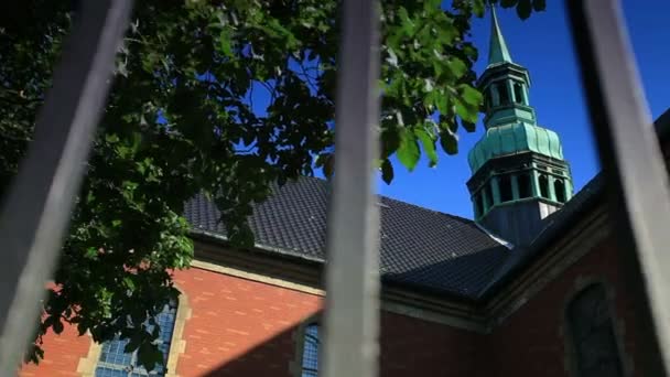 Church steeple through a fence in Copenhagen — Stock Video