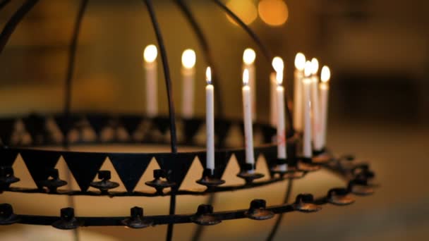 Candles in a candle holder inside a church — Stock Video