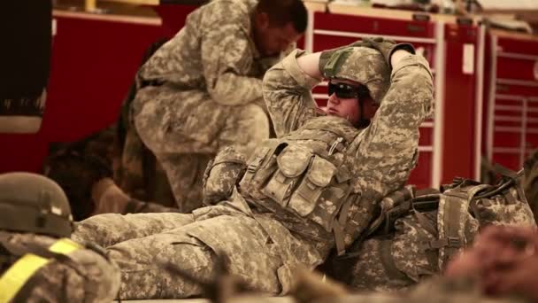 A Soldier lying on the ground, waiting at a hangar — Stock Video