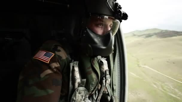 Soldier gazing out of helicopter door — Stock Video