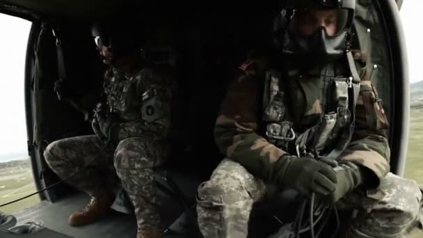 Two soldiers inside flying helicopter — Stock Video