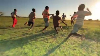 Children playing soccer on the fields in Kenya, Africa.