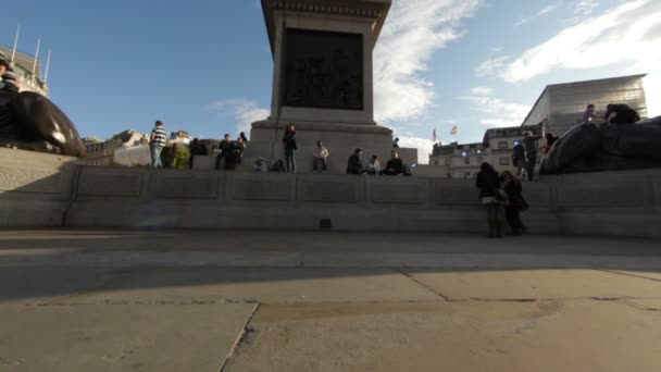 People at the foot of Lord Nelson's monument on Trafalgar Square — Stock Video