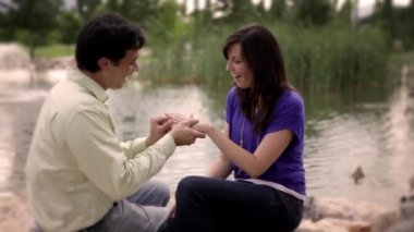 Woman looking gleeful as she shows a ring on her finger to her new fiance.