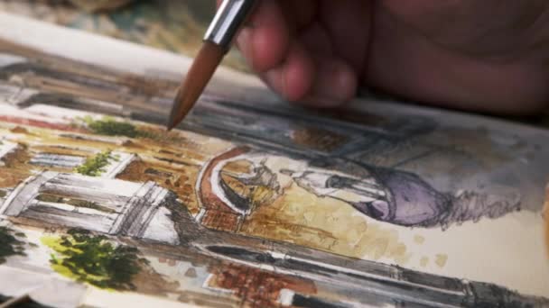 Close up shot of artist painting in details of a scene of a gondola on a canal in Venice. — Αρχείο Βίντεο