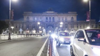 Time-lapse shot of the Palace of Justice from the bridge at night.