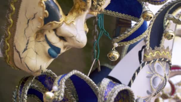 Close up tilting down shot of several elegant carnival masks. — Stock Video