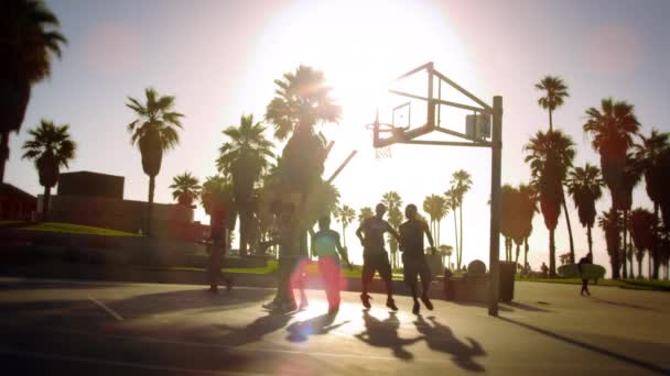 Basketball game in slow motion with lens flare shot near Venice Beach, California — Stock Video
