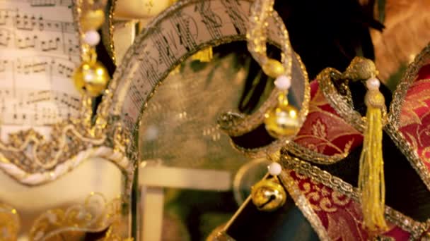 Tight tilting shot of several carnival masks. — Stock Video