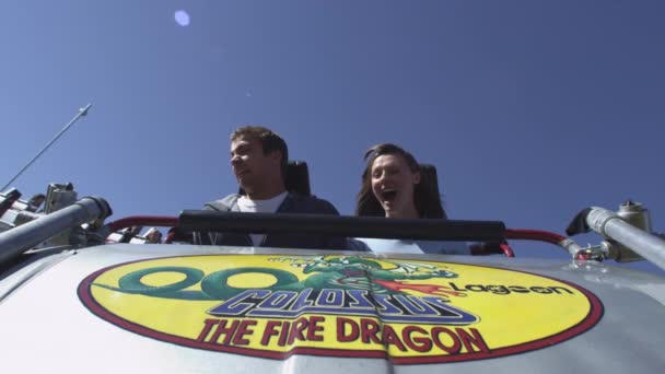 Couple riding a roller coaster — Stock Video