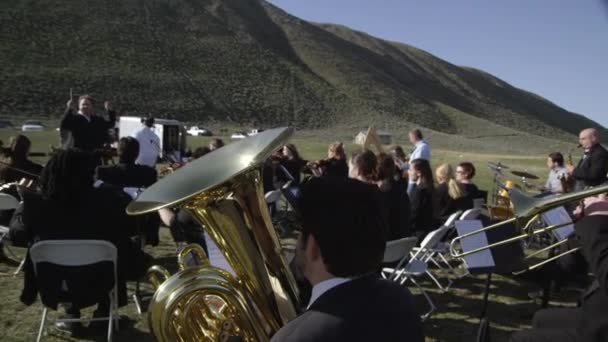 Orchestra performing outdoors — Stock Video