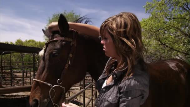 A slow motion shot of a woman adjusting a bridle. — Stock Video