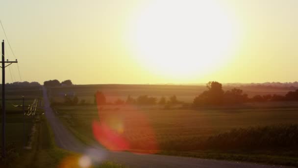 Static view of fields with the sun above the horizon. — Stock Video