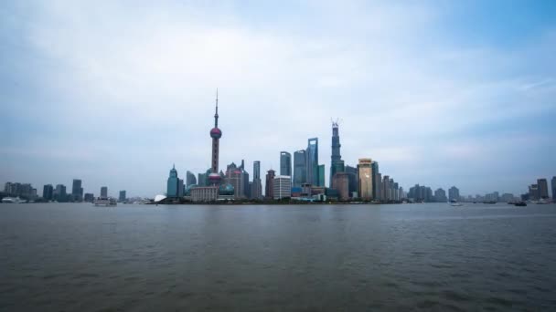 Wide time lapse of boats floating by with towers in the back in Shanghai China — Stock Video