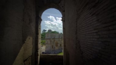 Arch of Constantine framed by a window in the Colosseum