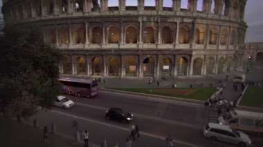 Cars and buses on street in front of Colosseum