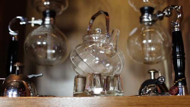 Glass empty teapot with metal handle with two Glass equipments for coffee. — Stock Video