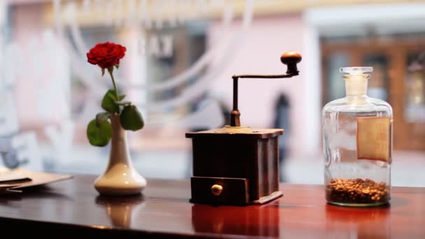 Rose rouge, moulin à café vintage avec un élégant chemin de coupe et une bouteille en verre avec café de luxe à l'intérieur sur une planche en bois . — Video