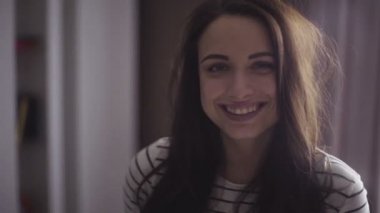 Footage of a model who is smiling on camera, girl is posing for a picture.