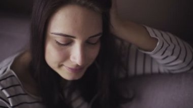 Girl listens to the music through smartphone,young female uses mobile device, panoramic shot.