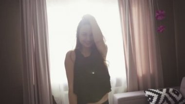 Slow motion footage with a girl making poses for camera like a mannequin.