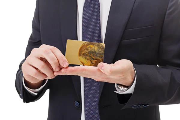 Close up of hands holding gold card on white background. Royalty Free Stock Photos