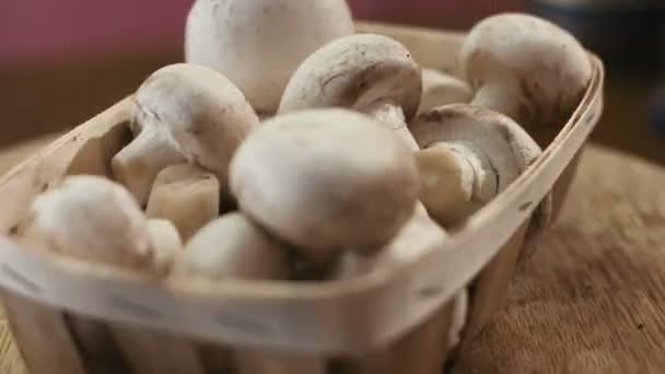 Heap of fresh and very tasty champignon mushrooms on a wooden background. — Stock Video