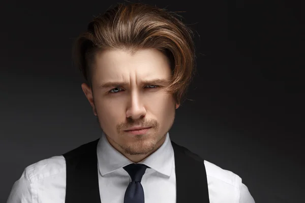 Handsome young gentelman wearing elegant white shirt  and black suit posing on camera. — Stock Photo, Image