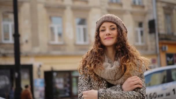 Amazing young woman wearing stylish brown hat standing in the street. — Stock Video