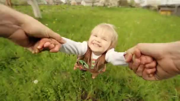 Тато тримає руки свого даустера, підкидаючи її на сад . — стокове відео