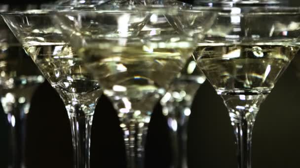 Vine  glasses in the form of a cascade or pyramid lit light at the party — Stock Video