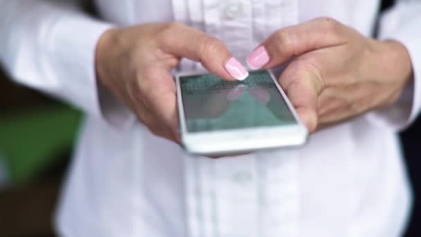 Close up of business woman in white shirt texting on smartphone. — Stock Video