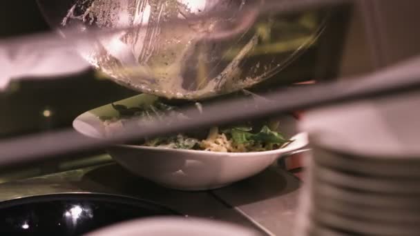 Serving a prepared salad into a plate — Stock Video