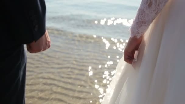 Newly married couple on tropical beach after sunset wedding, Romantic bride and groom — Stock Video