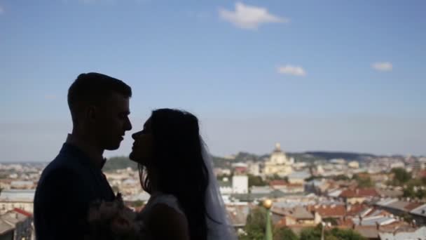 Silhouette of charming bride and groom embrace on the balcony in the old castle — Stock Video