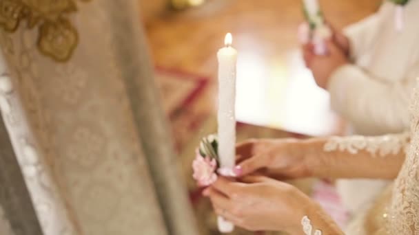 Jeune couple dans l'église tient des bougies de mariage — Video