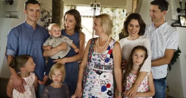 Gelukkige multi generatie familie plezier glimlachen, lachen op de camera in hun woonkamer — Stockvideo