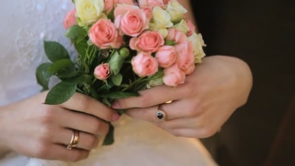 花嫁は、スローモーションで撮影された彼女の手に結婚式の花束を保持します — ストック動画