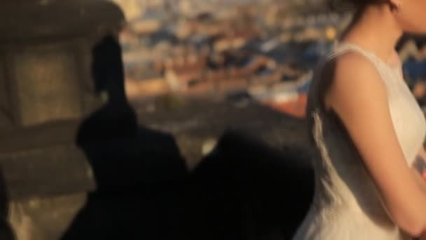 Wonderful rich groom looking at bride on the terrace on the background at sunset on a sunny warm city shot in slow motion  close up — Stock Video