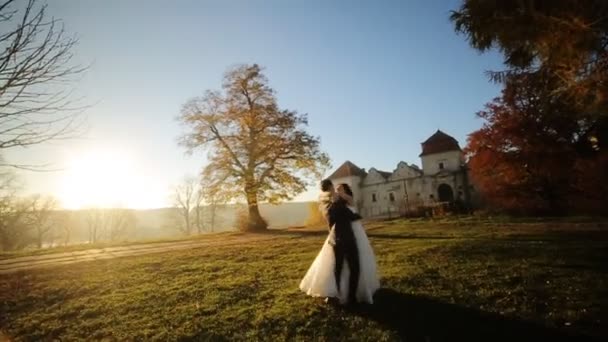 Házaspár tánc naplementekor. A vőlegény felemeli a menyasszony, és kiderül, ő lövés lassítva közelről — Stock videók