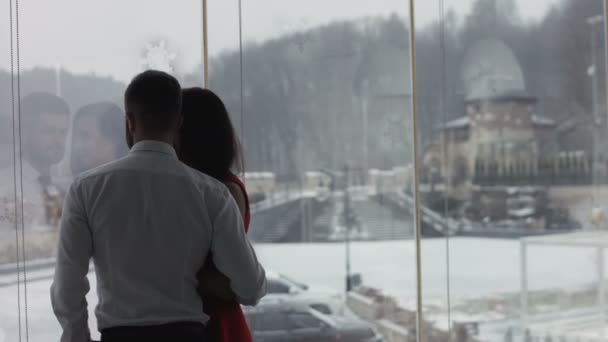 Young couple is standing near the window — Stock Video