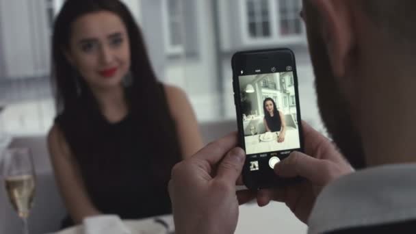 Sonriente pareja joven haciendo foto selfie en el teléfono inteligente en el interior — Vídeos de Stock